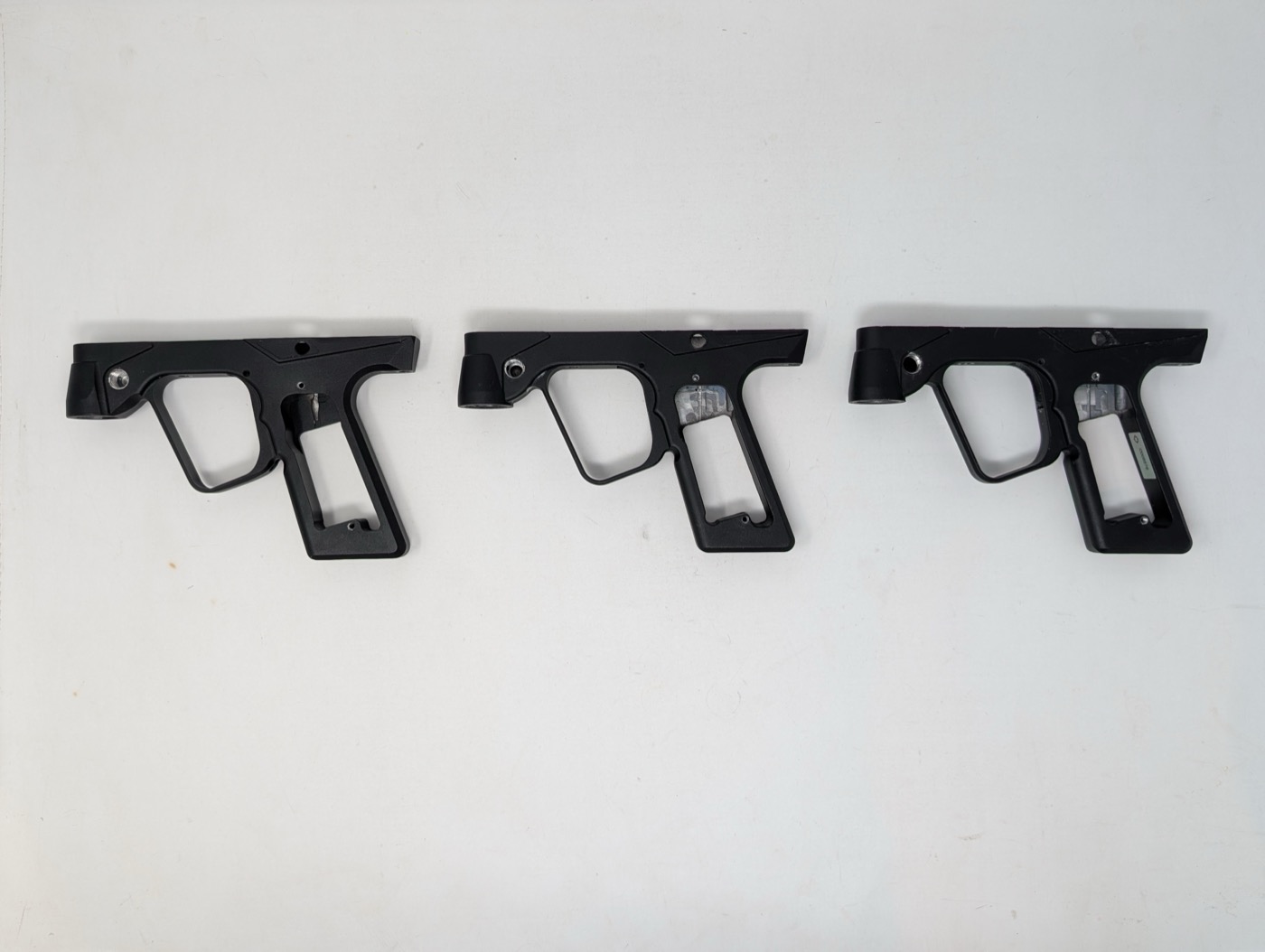 Same three frames from above — trigger guard shape and overall outline match across all three