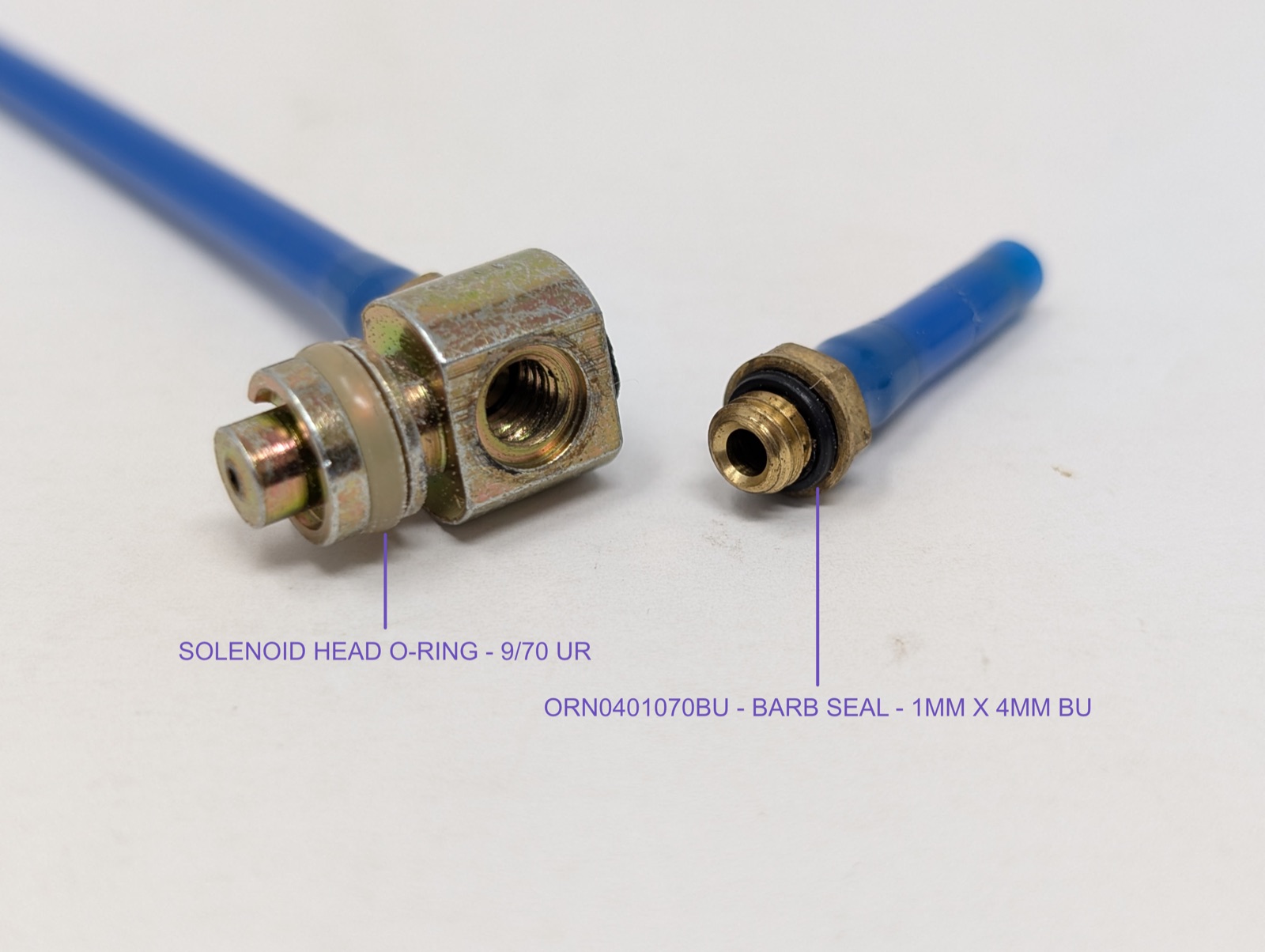 Solenoid head (left) and 4-mm barb fitting (right), both opened up to show their o-rings — solenoid head o-ring (9/70 UR, size not manual-sourced but confirmed by direct measurement) and barb seal (ORN0401070BU, 1mm x 4mm BU)