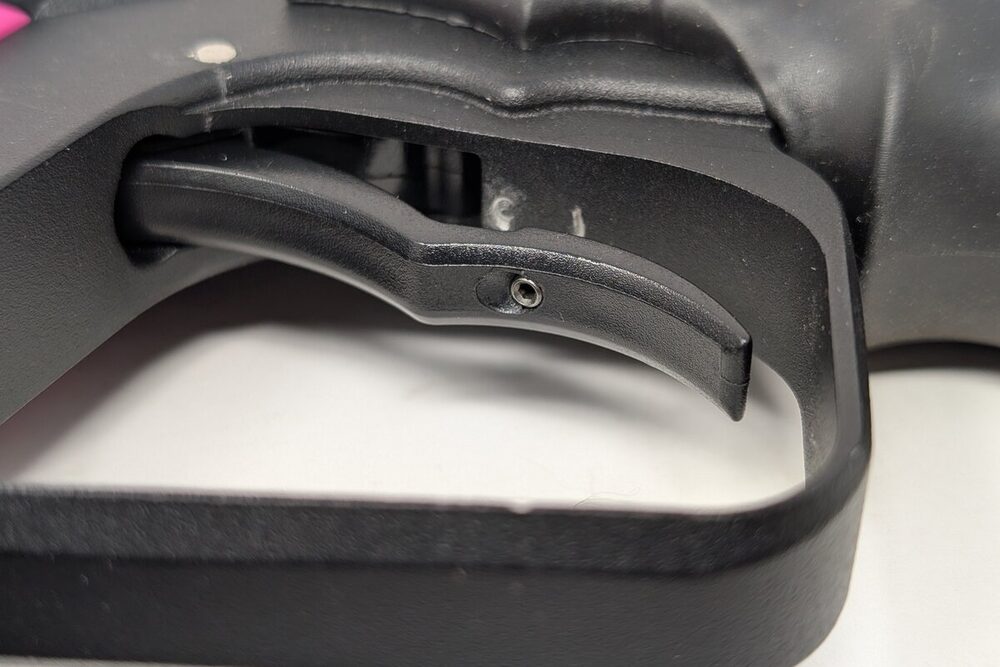 Post-travel screw location — small setscrew inside the trigger blade