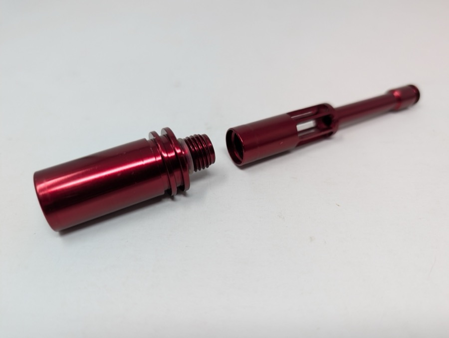 Firebolt disassembled into its two pieces — bolt head and tail — with the internal o-ring visible at the threaded joint